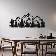 a dining room table with chairs and a wall mounted art piece on the wall behind it