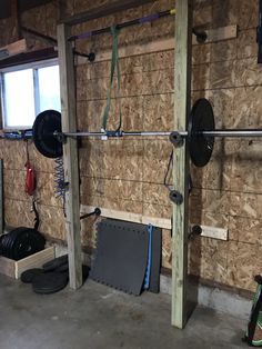 the inside of a home gym with wooden walls