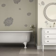 a white bath tub sitting next to a white sink under a mirror on a wall