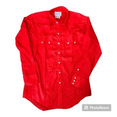 PEARL SNAP Western Shirt Vintage 70s Size Medium Size 16 Rockmount Ranch Wear Brand Diamond Snaps Red Cowboy Long Sleeve Button Up Made in USA A beautiful, bold red western style shirt with unique, diamond-shaped pearl snaps up the front, on cuffs, and pockets. Double-peaked, sawtooth chest pockets and double-peaked yoke on the back.  Brand: Rockmount Ranch Wear Tag Size: 16 (men's medium) Measurements available upon request. In great condition overall. No holes or stains. All snaps intact. Western Style Red Long Sleeve Tops, Red Western Long Sleeve Tops, Red Long Sleeve Western Top, Classic Red Tops With Snap Buttons, Fitted Red Tops With Snap Buttons, Vintage Red Tops For Rodeo, Western Red Tops For Spring, Western Style Red Tops For Spring, Spring Western Red Tops