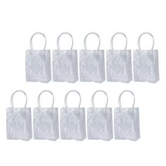 white plastic bags with handles are lined up in a row on a white background photo