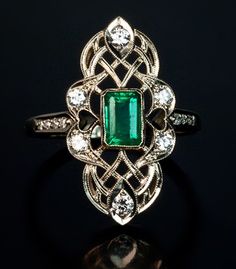 "𝐃𝐞𝐬𝐜𝐫𝐢𝐩𝐭𝐢𝐨𝐧 : *Victorian Art Deco Ring, Green Emerald Cut CZ Stone Ring, Antique Filigree Ring, Woman's Vintage Retro Dinner Ring, Unique Edwardian Ring. ❖ 𝐃𝐢𝐚𝐦𝐨𝐧𝐝 𝐃𝐞𝐭𝐚𝐢𝐥𝐬 *Color : White, Green *Clarity : VVS *Cut : Excellent *Center Stone Shape : Emerald Cut *Center Stone Size : 6*4 MM *Center Stone Weight : 0.50 CT *Side Stone Size : 1.40, 1.50, 1.60, 2.00 MM *Side Stone Weight : 0.34 CT *Total Carat Weight : 0.84 CT (Approx.) *Type : Cubic Zirconia (CZ) *We have all types of fancy & color Gemstone. For more queries please contact us immediately. ❖ 𝐑𝐢𝐧𝐠 𝐃𝐞𝐭𝐚𝐢𝐥𝐬 *Metal Purity : Solid Gold (10K, 14K, 18K); 925 Sterling Silver *Stamp : Yes (As per metal purity) *SKU : SR4870 *Making Process : Handmade > Crafted by our experienced craftsman. ❖ 𝐂𝐮𝐬𝐭𝐨? Art Deco Women, Art Deco Emerald, Art Deco Emerald Ring, Fake Wedding, Vintage Art Deco Rings, Edwardian Ring, Antique Filigree, Platinum Diamond Engagement Rings, Green Rings