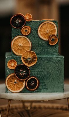 a green cake with orange slices on it