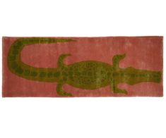 a rug with an image of a green alligator on it's back and pink background