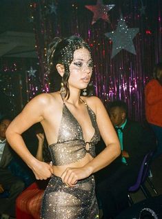 a woman in a silver dress posing for the camera