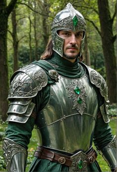 a man dressed as a knight standing in the woods with his hands on his hips