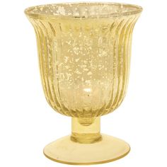 a yellow glass vase sitting on top of a table