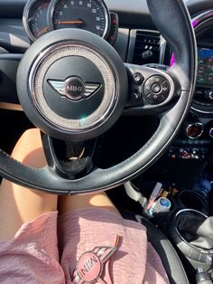 the interior of a car with steering wheel and dashboard