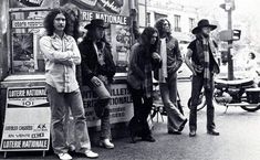 an old black and white photo of some people standing in front of a food truck