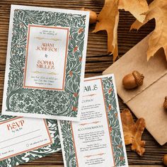 wedding stationery with leaves and acorns on wooden table