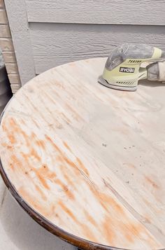 an ironing board sitting on top of a wooden table next to a white door