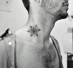 a man with a small snowflake tattoo on his neck and back of the neck