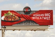 an advertisement for korean bbq with a twist on a billboard in front of the sky