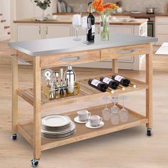 a kitchen island with wine bottles and glasses on it in the middle of a room