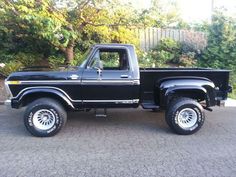 a black pick up truck parked in a driveway