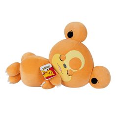 an orange stuffed animal laying on its back