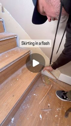 a man in black shirt and hat working on wood floor next to stairs with text overlay