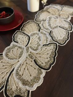 the table runner is decorated with sequins and beads