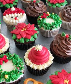 many decorated cupcakes are sitting on a table with frosting and icing