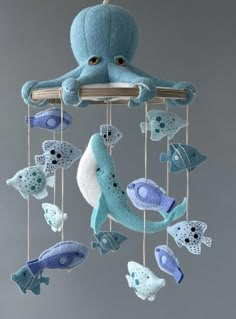 an octopus mobile is hanging from the ceiling with blue and white sea creatures on it