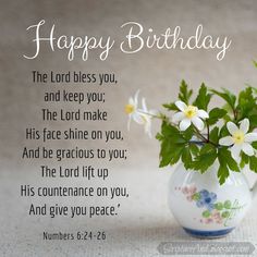 a vase filled with white flowers on top of a table next to a card saying happy birthday