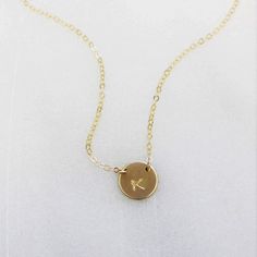 "This stunning petite initial necklace can be customized with a special initial of your choice. Choose from sterling silver, 14kt gold filled or rose gold filled. Classic and timeless, perfect for everyday wear. D E T A I L S -Petite disc measures 10mm - Choose from sterling silver, 14kt gold filled or rose gold filled. -A high quality delicate chain with a spring clasp. -Polished to a light satin finish. CUSTOM HAND STAMPING -Each disc is hand stamped with your initial -Choose your font in phot