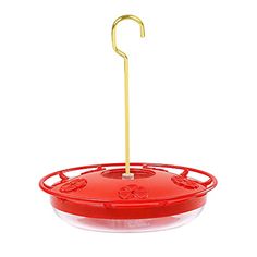 a red bird feeder with a metal hook on it's side and a yellow stick sticking out of the top