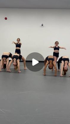 a group of people standing on top of each other in front of a white wall