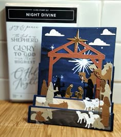 a nativity scene with the birth of jesus and three wise men, in front of a christmas card