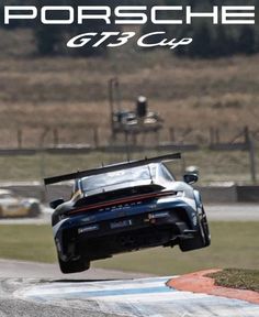 the porsche gt3 cup car is flying through the air