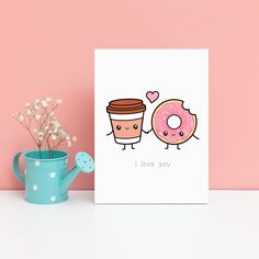 a greeting card with two donuts and a cup of coffee on the table next to it