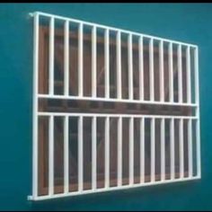 an image of a window with bars on the outside and in the inside, against a blue wall