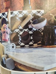 a kitchen counter with pots and pans on it