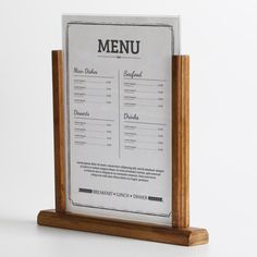 a wooden menu holder with a menu on it