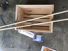 two chopsticks are sticking out of a wooden box