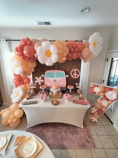 a table topped with balloons and decorations