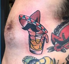 a man's neck with tattoos on it and an image of a mexican drink