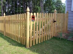 a large wooden fence in the grass