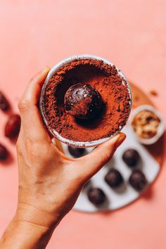 a person holding a cup filled with chocolate