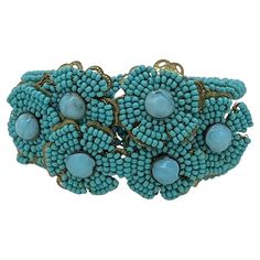 This is a Stanley Hagler hinge clamp bracelet. It is wrapped around with turquoise color seed beads and features six hand wired flowers on brass filigree. It's very similar to Stanley Hagler's beading style but is not signed. Our vintage jewelry collection and original creations are all unique listings. We never have multiple copies of anything. So, if you miss the current opportunity you may not get another chance to own the piece you love. It usually takes us one day to ship out orders excepting weekends. We have 20 years of online business and shipping experience. We have quite different inventory for our physical store and online listings, so you are welcome to stop by to browse a lot more jewelry when you are in Atlanta. Clamp Bracelet, Brass Filigree, Wire Flowers, Antique Bracelets, Diamonds And Gold, Turquoise Color, Hinges, 20 Years, One Day