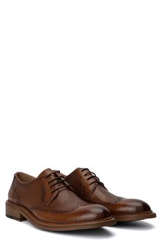 Herringbone pattern woven details meet a wingtip toe silhouette to create this unique lace-up. Round wingtip toe Broguing details Woven texture details Lace-up Leather upper, manmade sole Imported Brown Wingtip Oxfords With Textured Sole, Brown Wingtip Lace-up Shoes With Textured Sole, Vintage Brown Lace-up Shoes For Business, Brown Cap Toe Lace-up Shoes With Perforated Toe Box, Formal Brown Lace-up Shoes With Perforated Toe Box, Brown Lace-up Derby With Brogue Detailing, Woven Texture, Herringbone Pattern, Curator Style