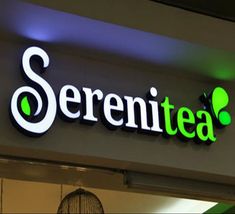 there is a sign that says serentea above the entrance to a store with lights on