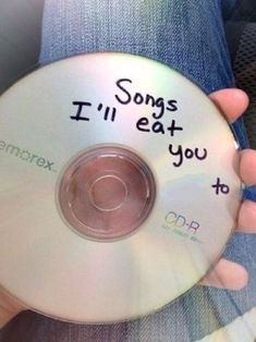 someone holding up a cd with the words i'll eat you to