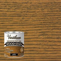 a can of wood stain sitting on top of a wooden floor