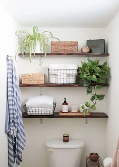 the bathroom is clean and ready to be used as a place for towels, toilet paper, and other items