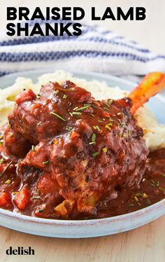 meatballs and mashed potatoes are served in a blue bowl on a wooden table