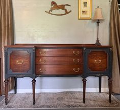 an old fashioned dresser is in the corner of a room with curtains on the wall