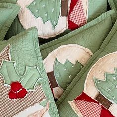 some green and red quilts with christmas trees on them