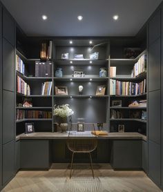 an image of a home office with built in bookshelves and desks on the walls