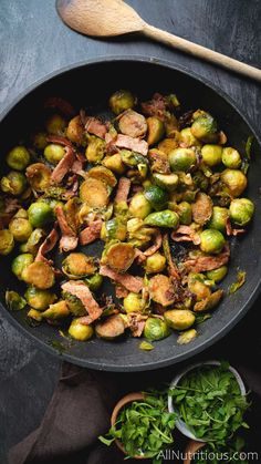 brussel sprouts and bacon in a skillet with a wooden spoon